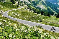 Radfahrer auf einer Strasse in den Bergen.